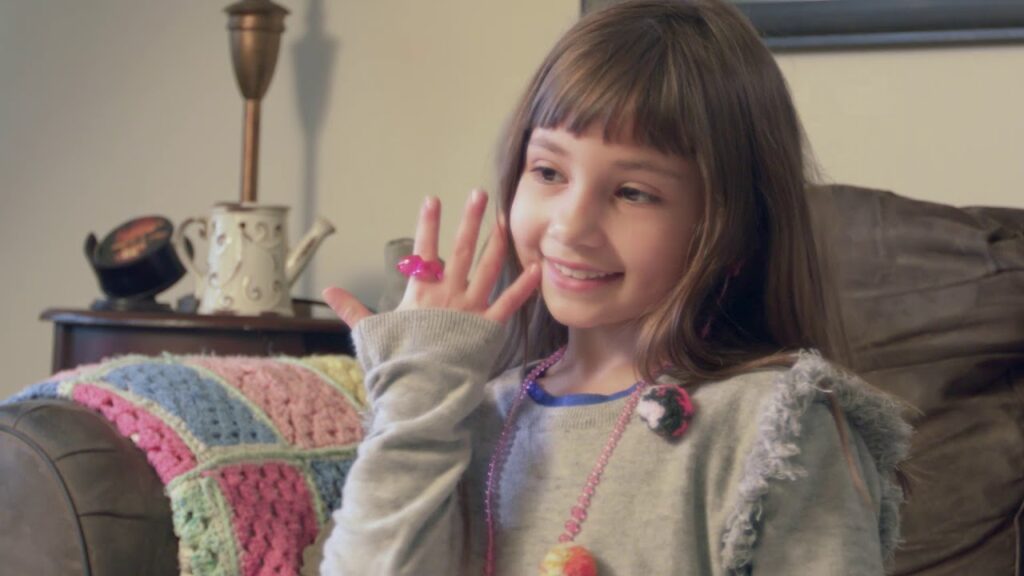 Girl showing off Pretty Pretty Princess jewelry